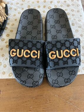 Gucci Black Slides with Gold Logo Embellishment